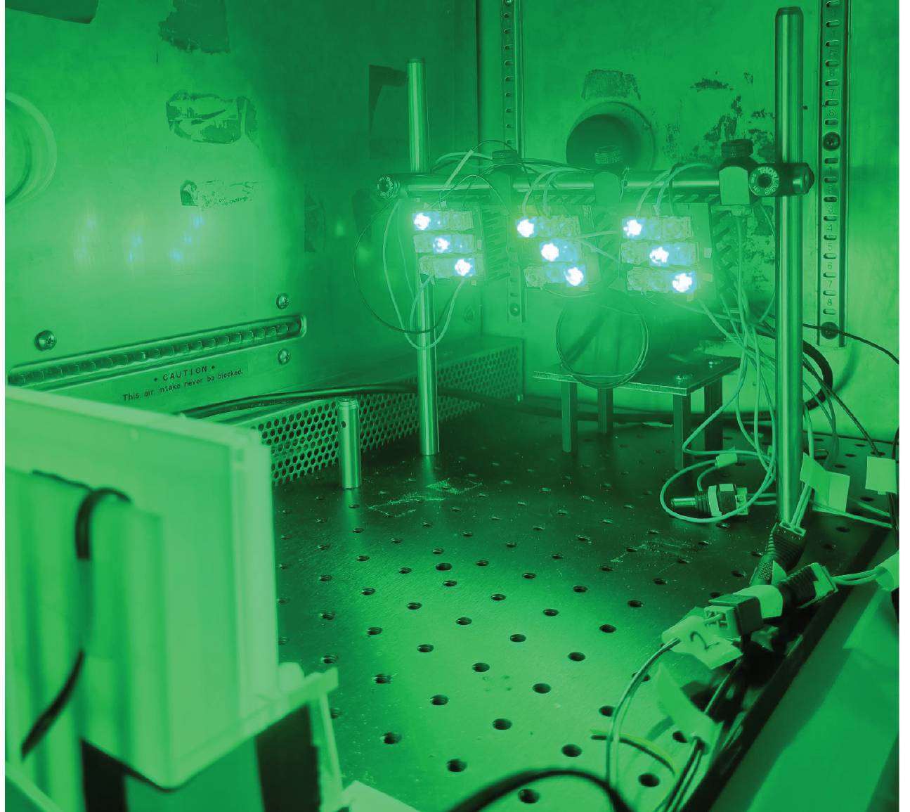Green-lit climbing assay rig inside the incubator